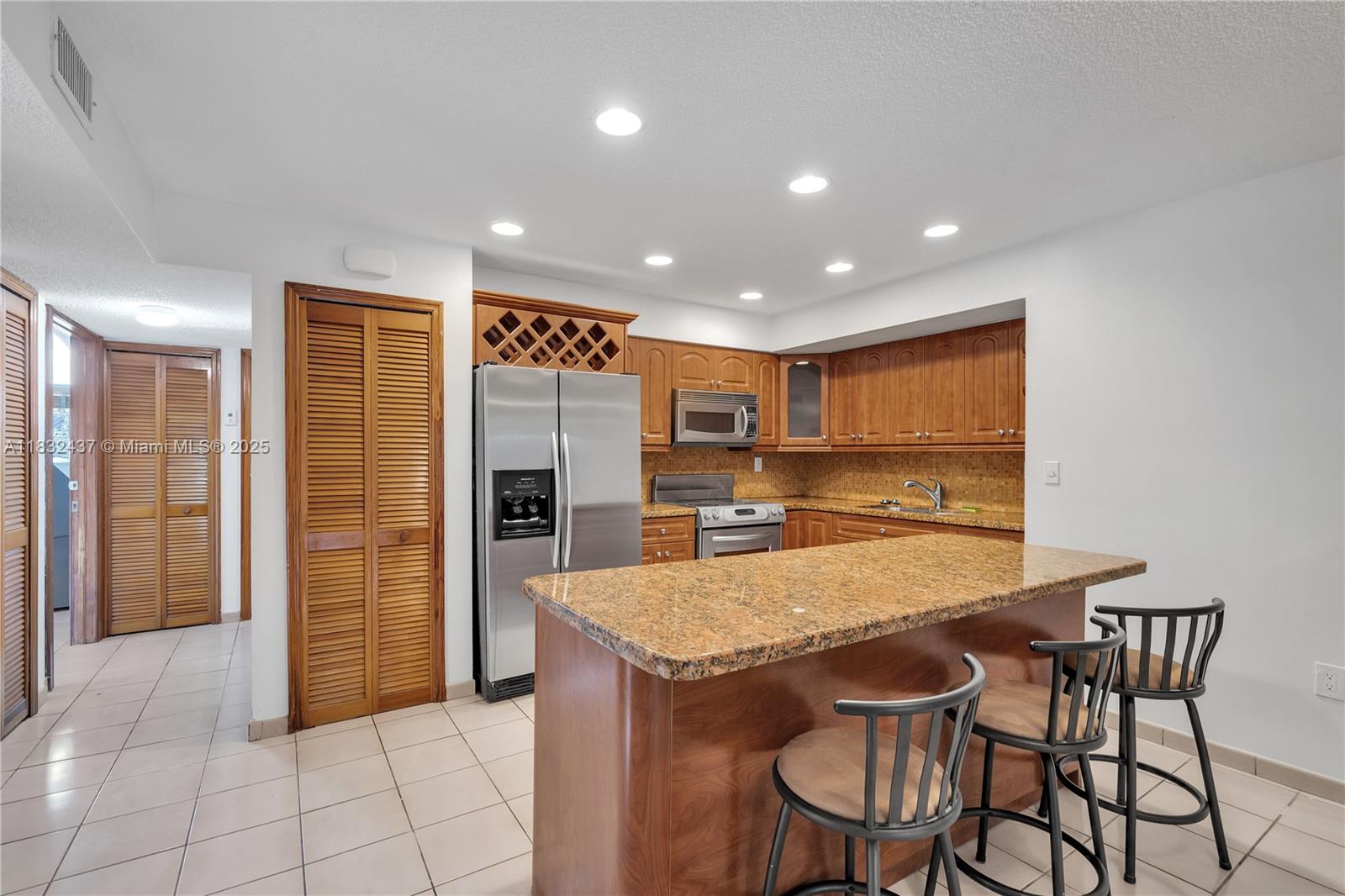 7811 Southwest 9th Terrace Miami, FL 33144 - Photo 9 of 27 a kitchen with stainless steel appliances a refrigerator and microwave