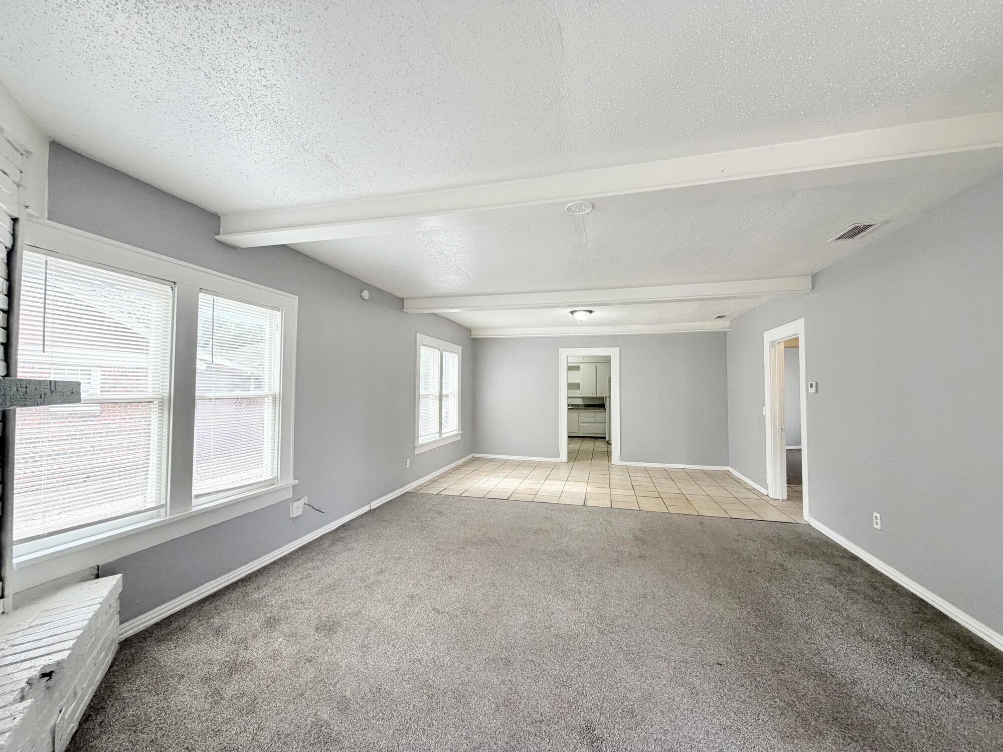 2119 15th Street Lubbock, TX 79401 - Photo 4 of 15 a view of an empty room with a window
