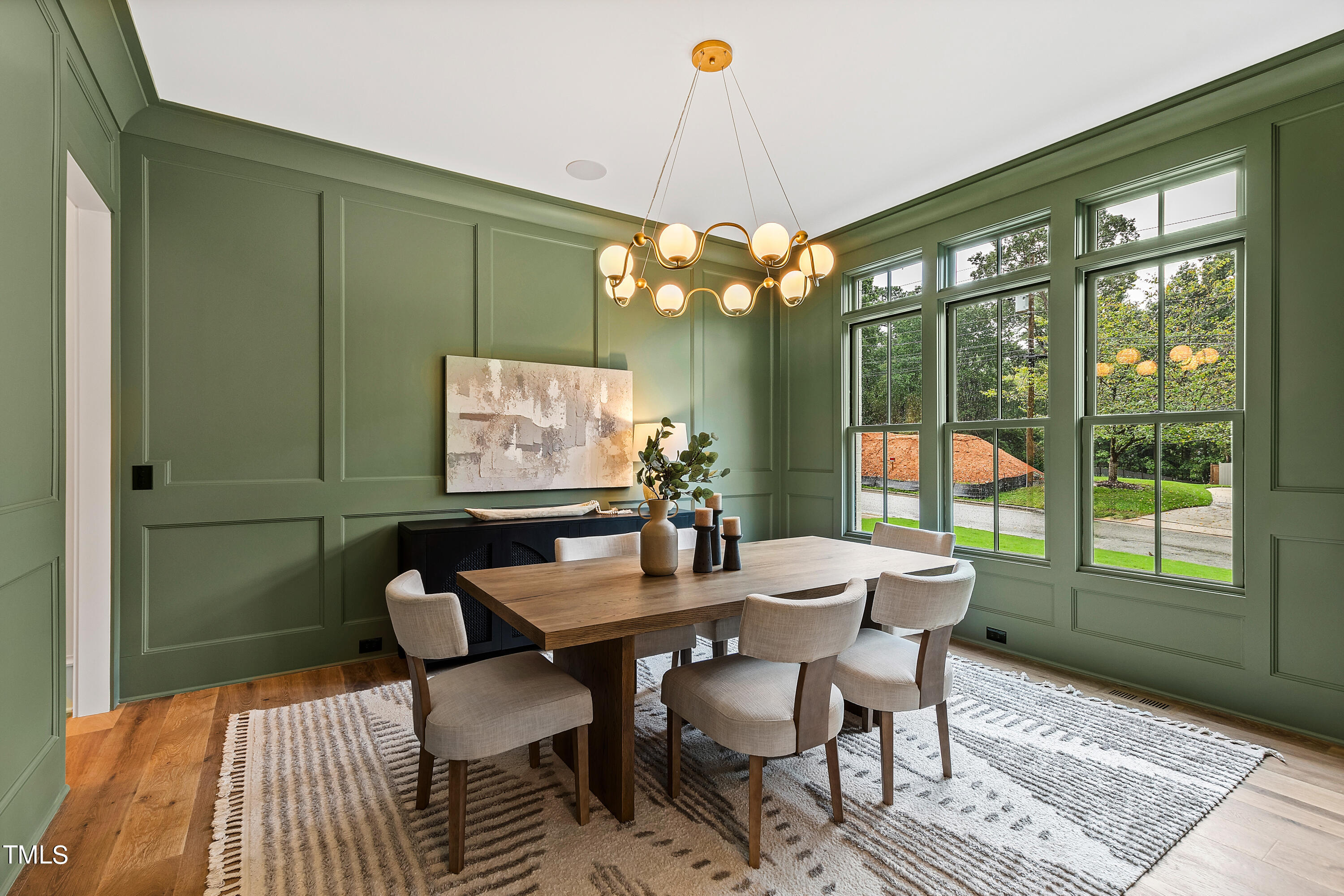 1104 Manchester Drive Raleigh, NC 27609 - Photo 3 of 52 a view of a dining room with furniture wooden floor and chandelier