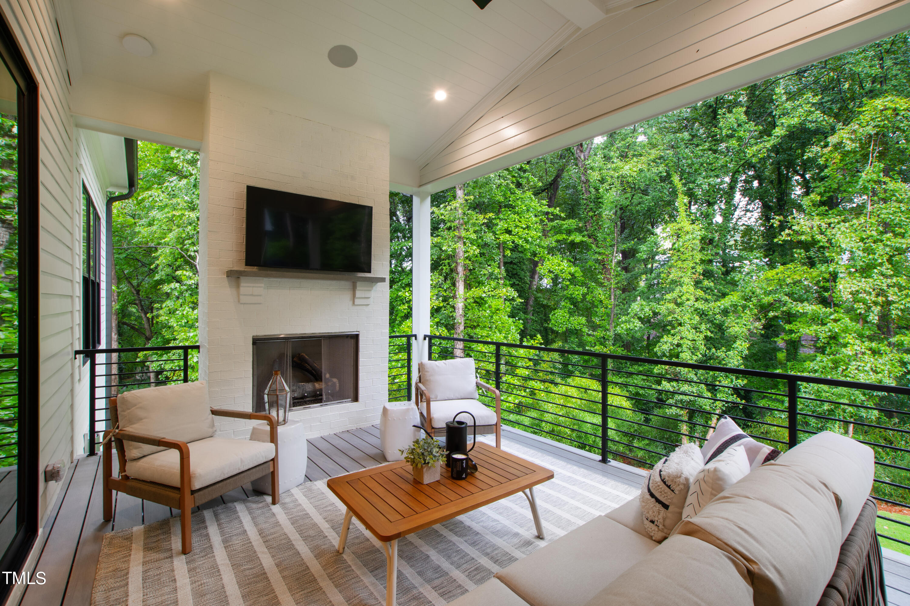 1104 Manchester Drive Raleigh, NC 27609 - Photo 52 of 52 a view of a patio with couches chairs and a floor to ceiling window