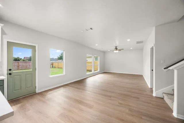 wooden floor in an empty room with a window