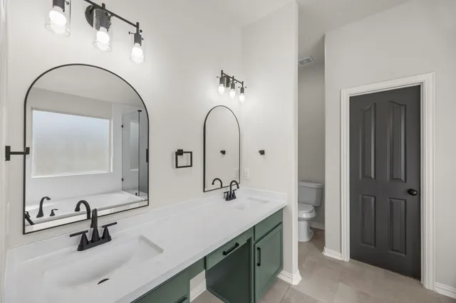 a bathroom with a double vanity sink and a mirror