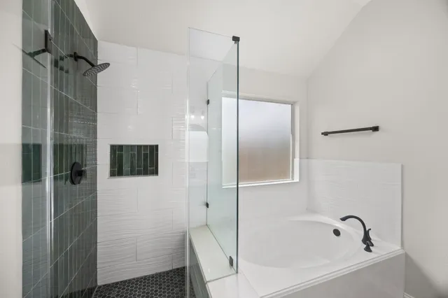 a bathroom with a bathtub and a shower