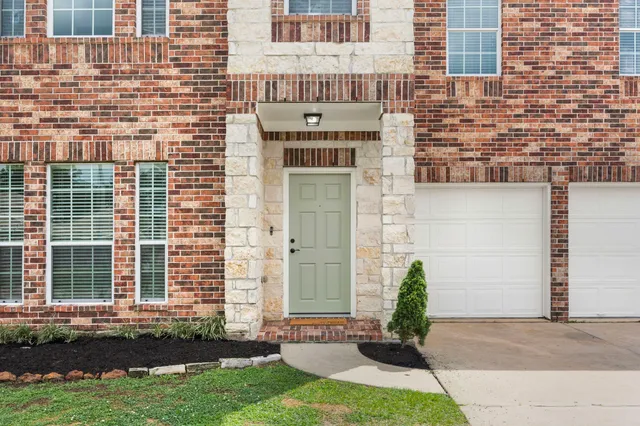 a front view of a house with a yard and outdoor seating