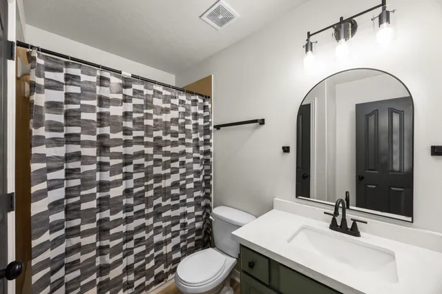 a bathroom with a sink toilet and shower