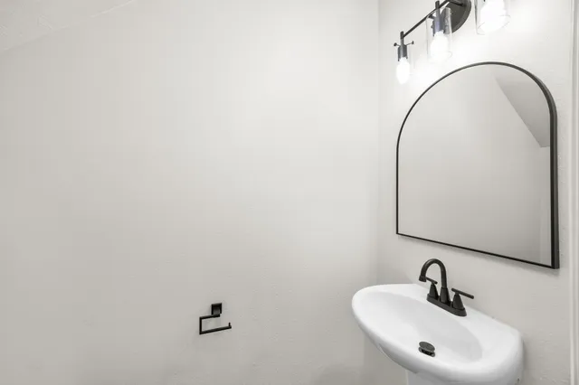 a bathroom with a sink and mirror