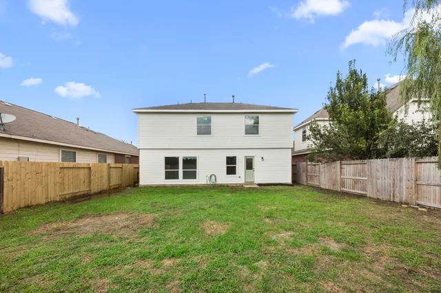 a view of a house with a yard and sitting area