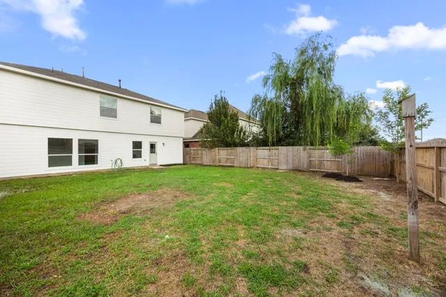 a view of a backyard with plants and a backyard