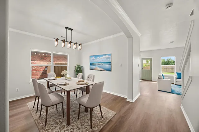 a view of a dining room with furniture window and wooden floor