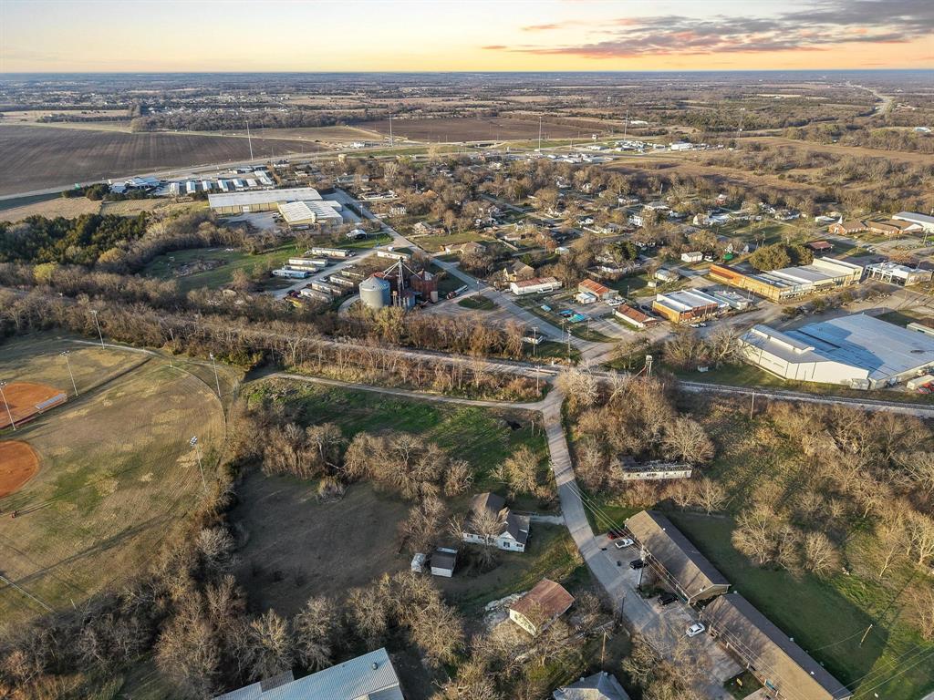 120 Holmes Street, Unit LOT 2 Trenton, TX 75490 - Photo 12 of 21 an aerial view of residential houses with outdoor space