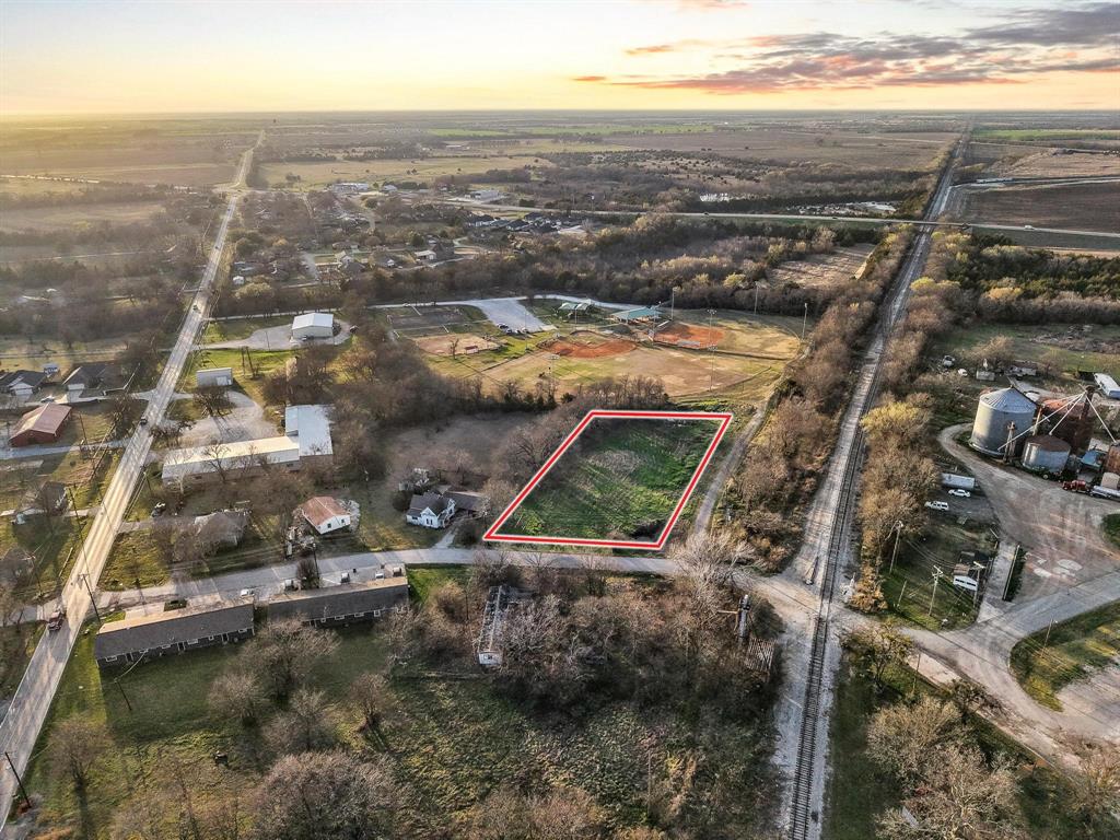 120 Holmes Street, Unit LOT 2 Trenton, TX 75490 - Photo 14 of 21 an aerial view of residential houses with outdoor space