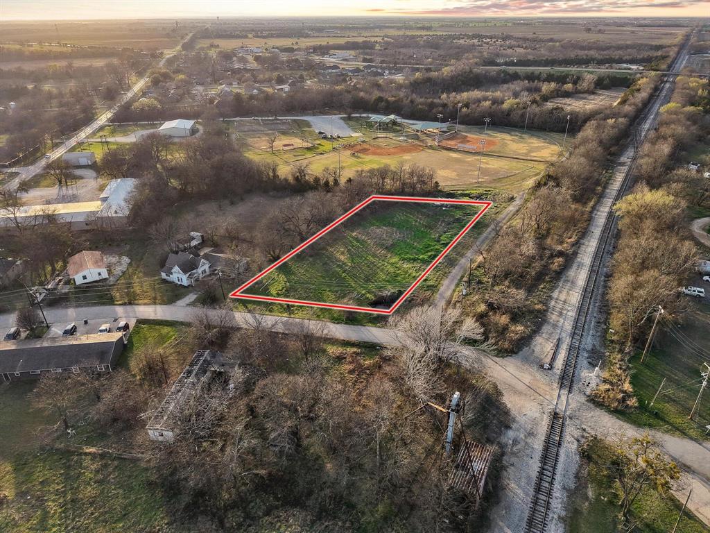 120 Holmes Street, Unit LOT 2 Trenton, TX 75490 - Photo 6 of 21 an aerial view of residential houses with outdoor space