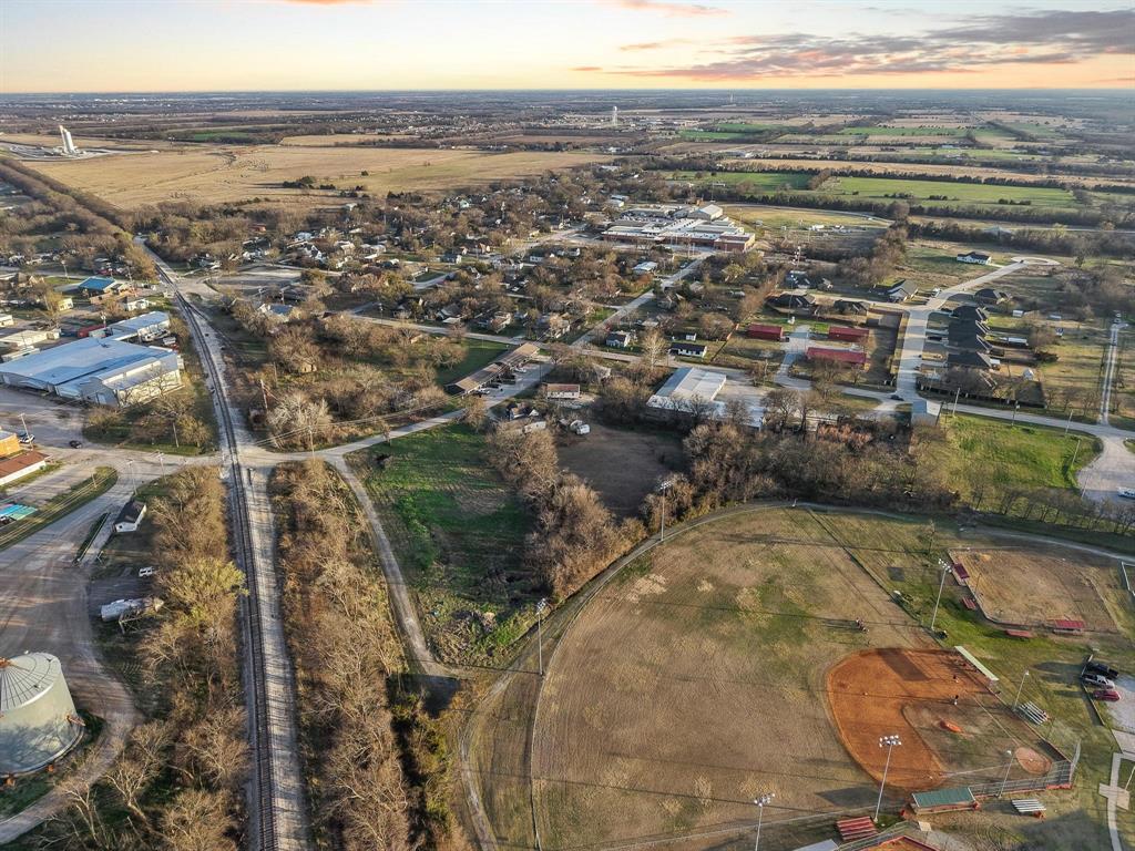 120 Holmes Street, Unit LOT 2 Trenton, TX 75490 - Photo 10 of 21 an aerial view of residential houses with outdoor space