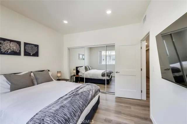 a bedroom with a bed and a flat screen tv