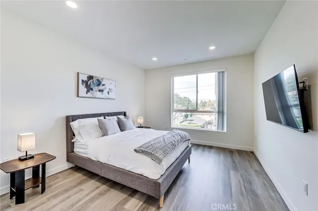a bedroom with a large bed and a chandelier