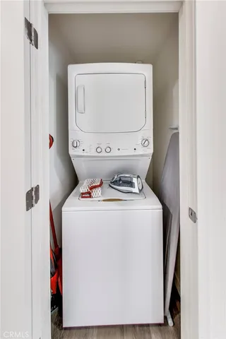 a balcony with couple of chairs and a potted plant