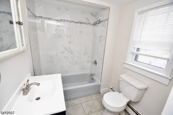 a bathroom with a toilet and a bathtub