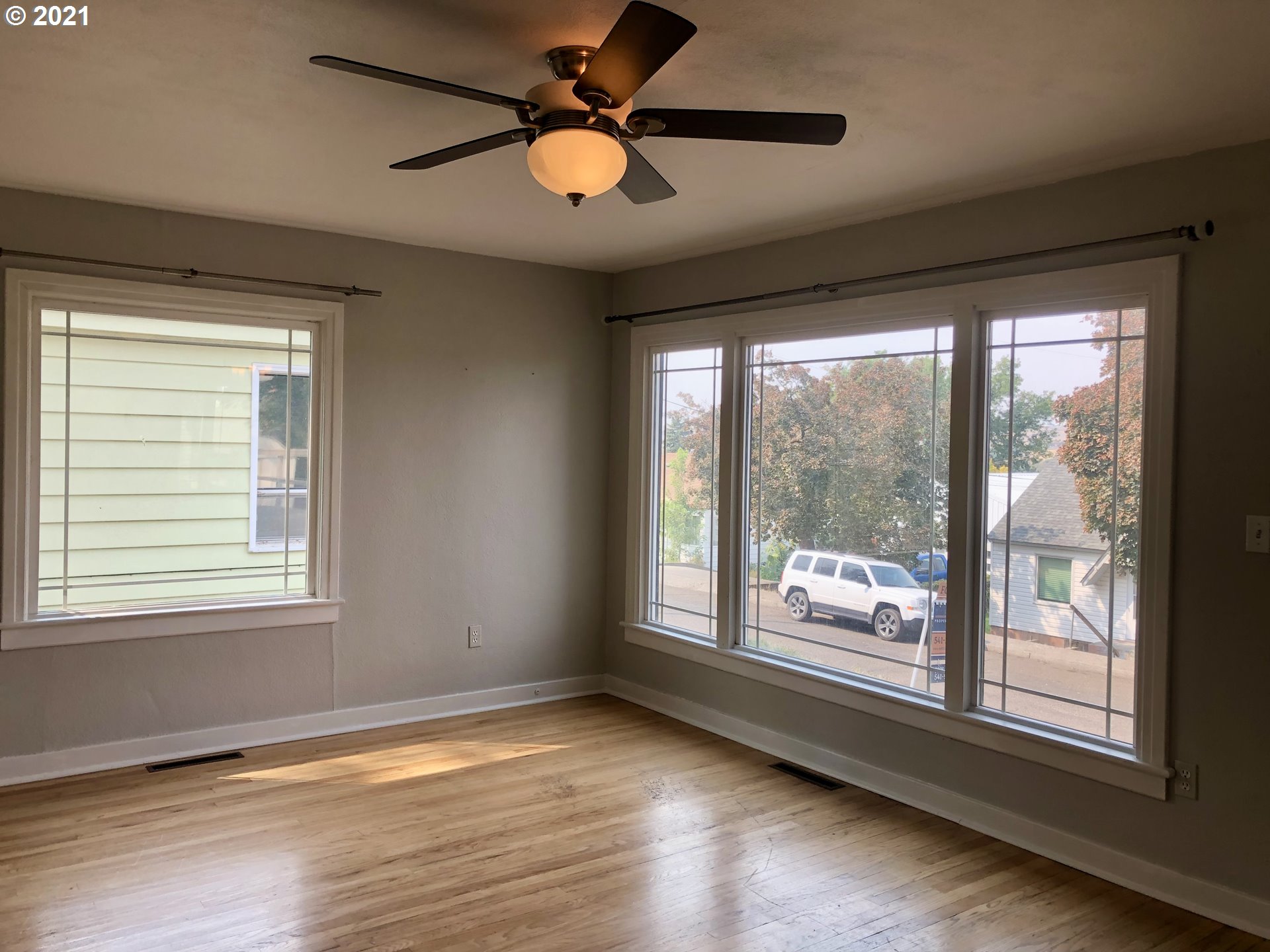 924 Southwest Goodwin Place Pendleton, OR 97801 - Photo 3 of 23 a view of an empty room with wooden floor and a window