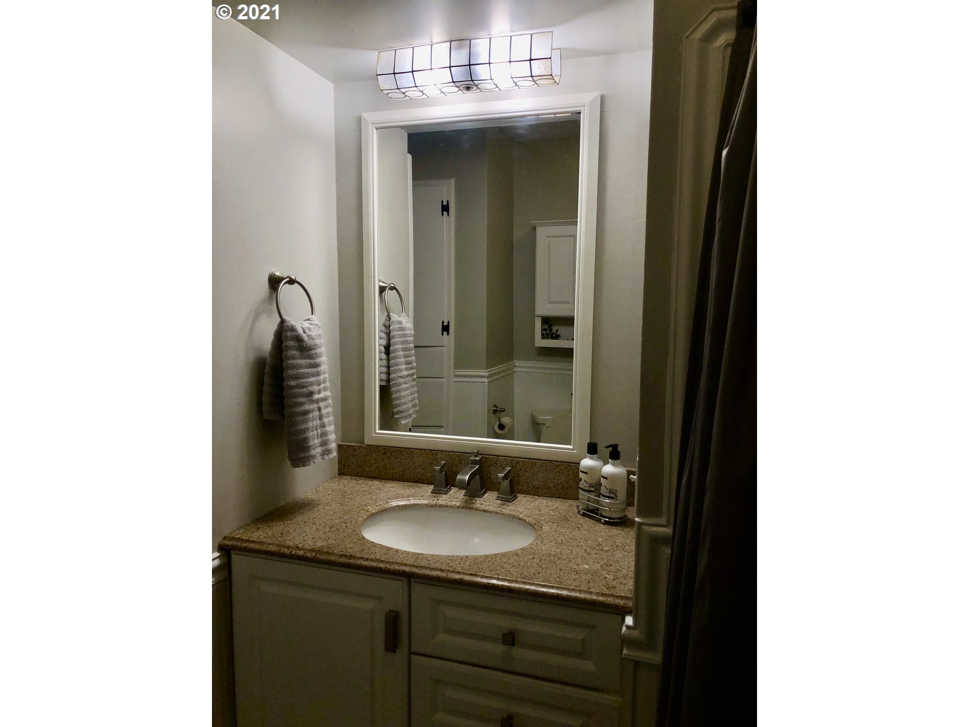 924 Southwest Goodwin Place Pendleton, OR 97801 - Photo 10 of 23 a bathroom with a granite countertop sink and a mirror