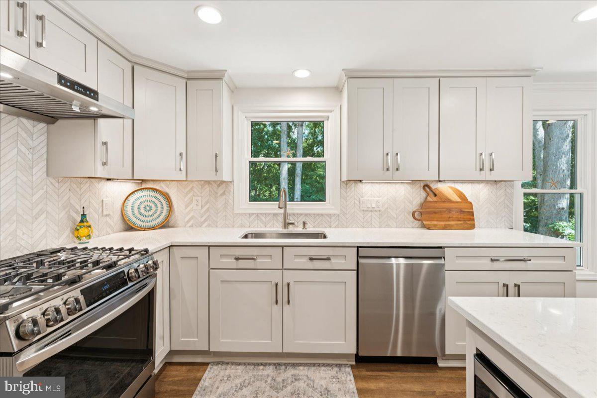 1377 Rock Chapel Road Herndon, VA 20170 - Photo 15 of 65 a kitchen with a sink stove and cabinets