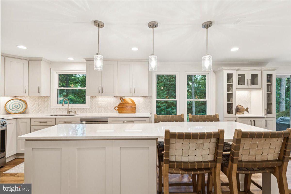 1377 Rock Chapel Road Herndon, VA 20170 - Photo 2 of 65 a kitchen with kitchen island granite countertop a table chairs sink and cabinets