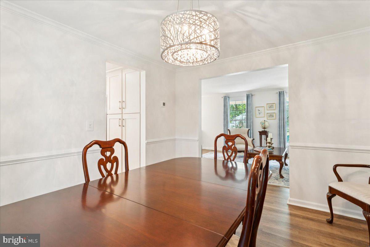 1377 Rock Chapel Road Herndon, VA 20170 - Photo 22 of 65 a view of a dining room with furniture and a chandelier