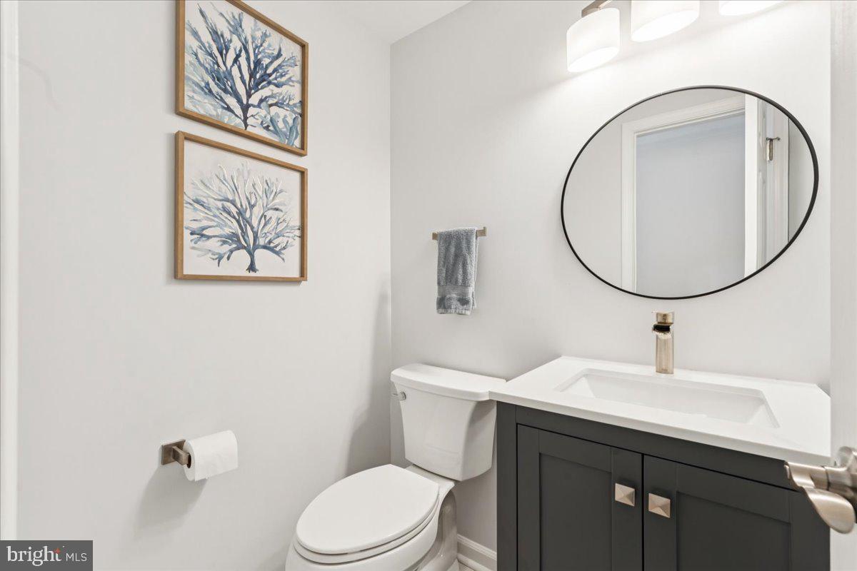 1377 Rock Chapel Road Herndon, VA 20170 - Photo 26 of 65 a bathroom with a toilet a sink and a mirror