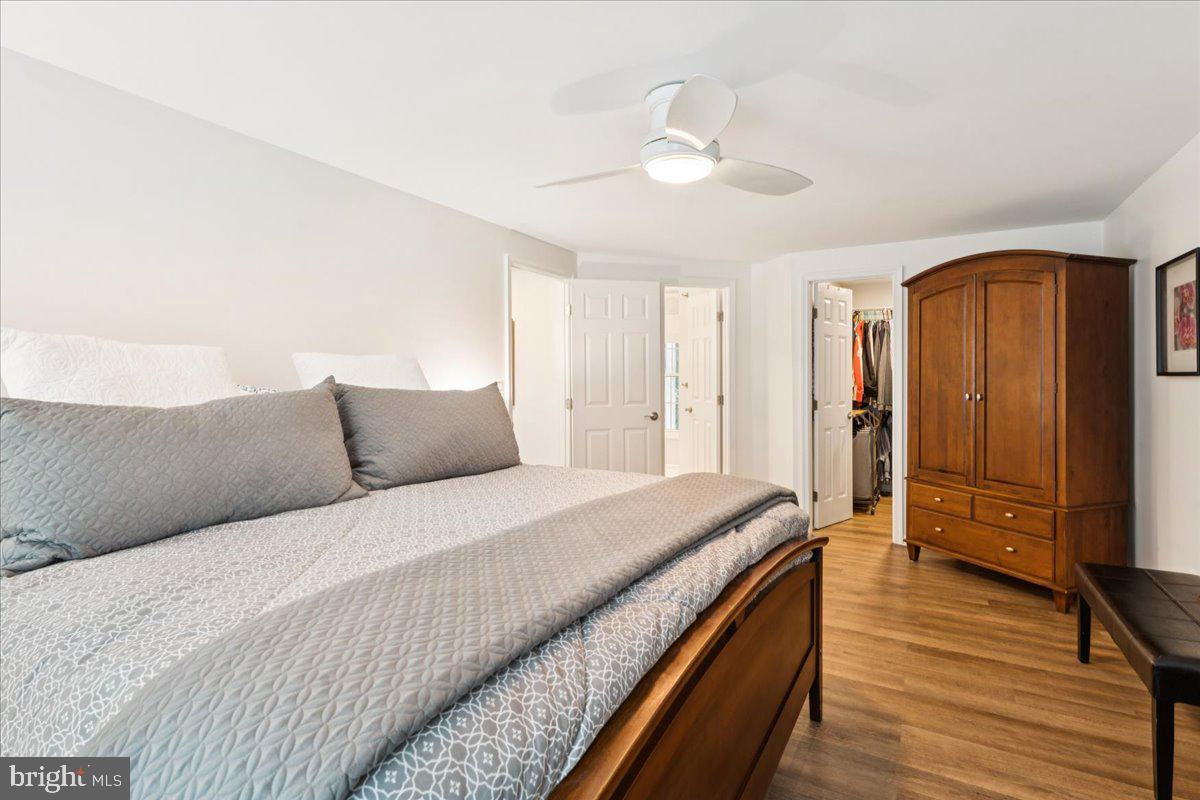 1377 Rock Chapel Road Herndon, VA 20170 - Photo 29 of 65 a spacious bedroom with a bed and a chandelier