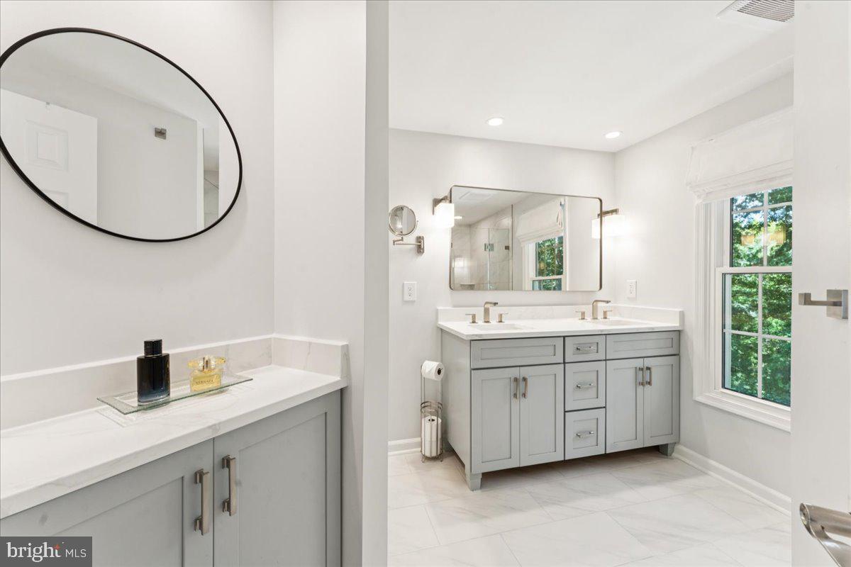 1377 Rock Chapel Road Herndon, VA 20170 - Photo 30 of 65 a bathroom with a sink double vanity and a mirror