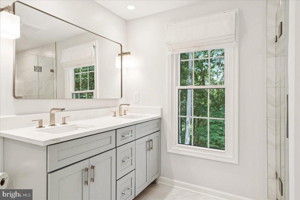 1377 Rock Chapel Road Herndon, VA 20170 - Photo 32 of 65 a bathroom with a double vanity sink a mirror and next to a window