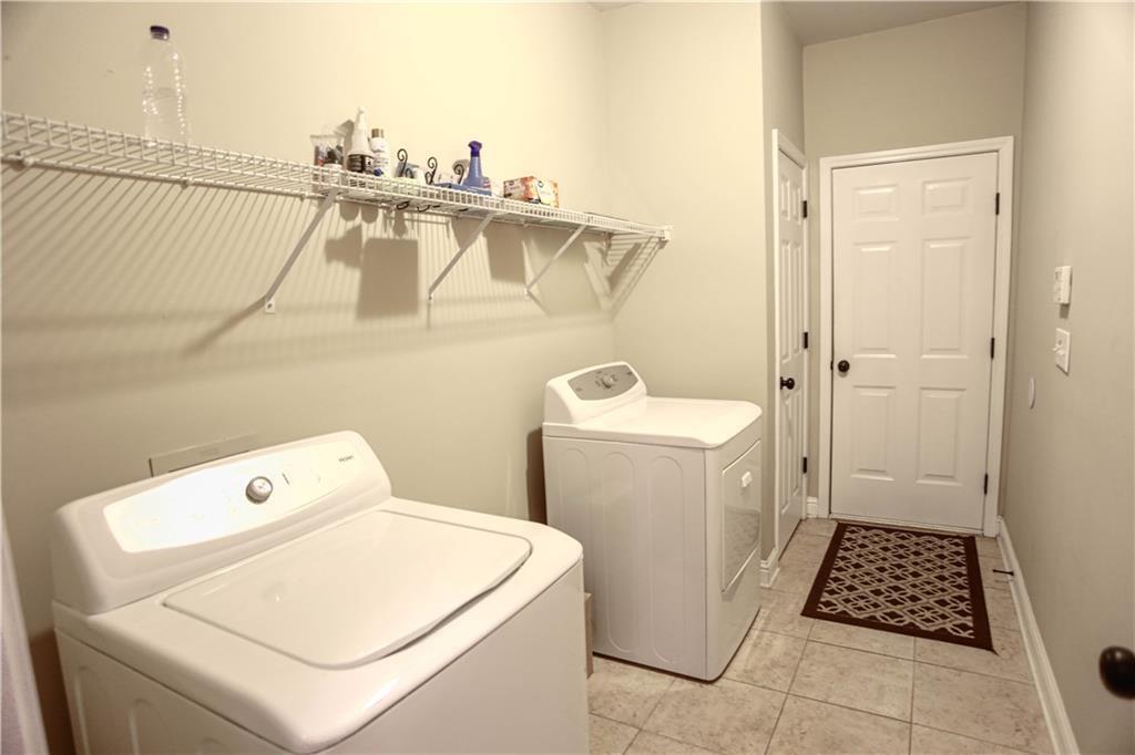 3875 Spring Manor Court Loganville, GA 30052 - Photo 15 of 23 a utility room with dryer and washer