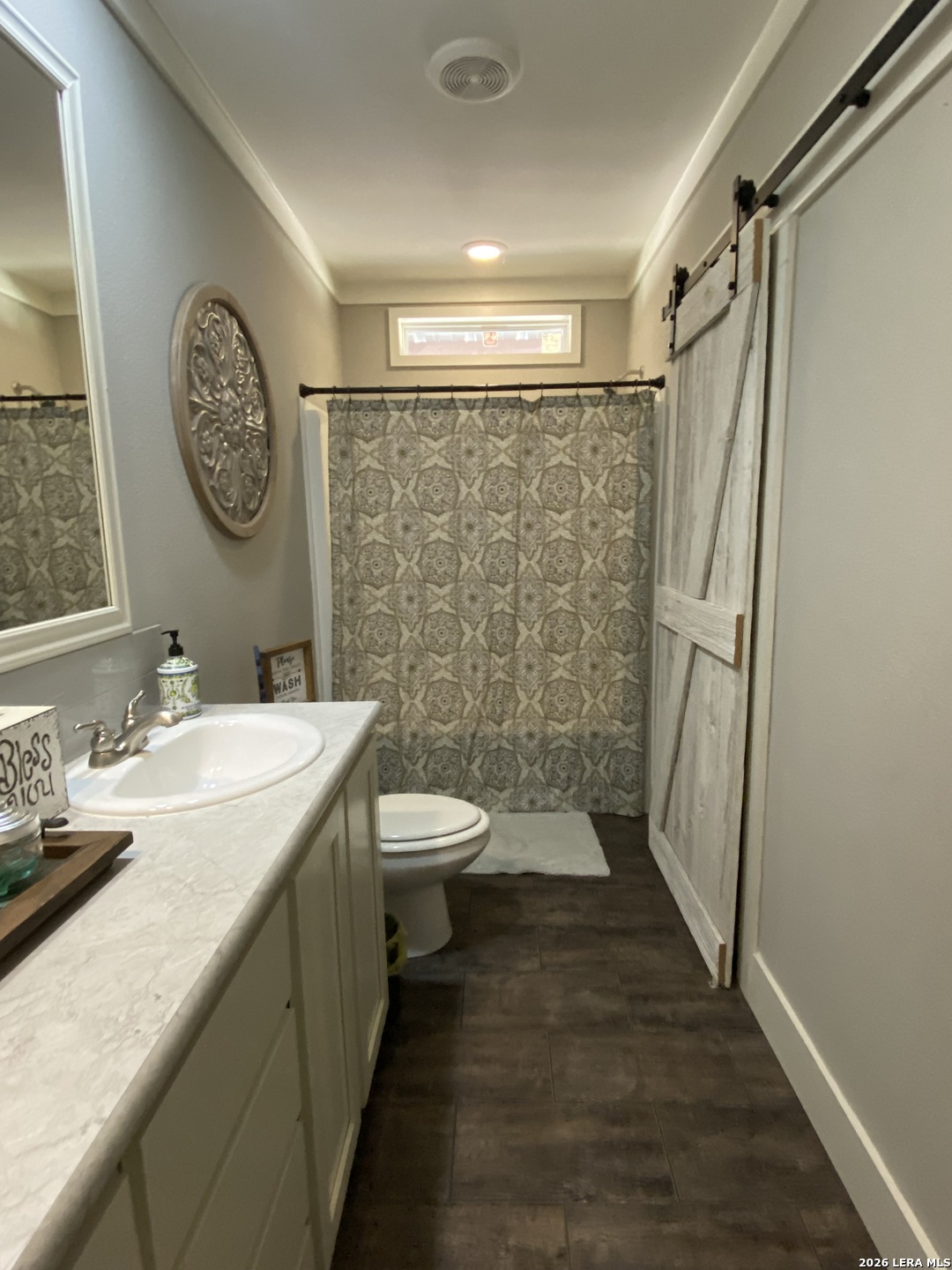 316 County Road 775 Devine, TX 78016 - Photo 5 of 10 a bathroom with a granite countertop toilet a sink and a shower