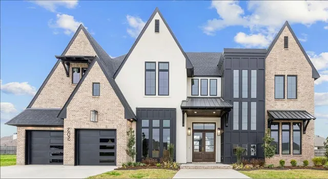 a view of a brick house with large windows