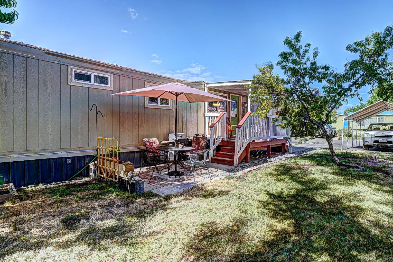 585-25 25 1/2 Road, Unit 72 Grand Junction, CO 81505 - Photo 20 of 21 a view of a house with backyard tub and sitting area