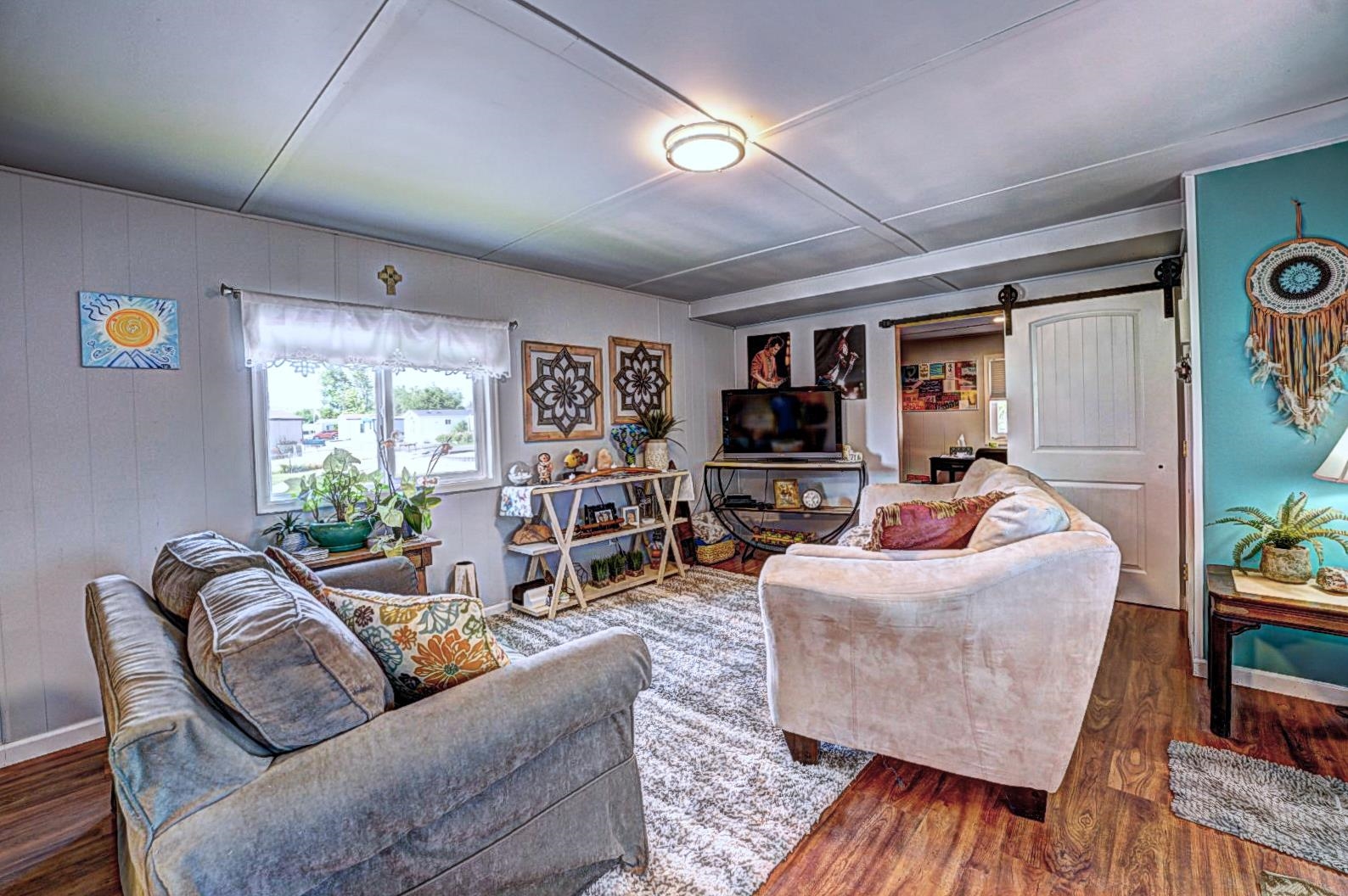 585-25 25 1/2 Road, Unit 72 Grand Junction, CO 81505 - Photo 6 of 21 a living room with furniture and a flat screen tv