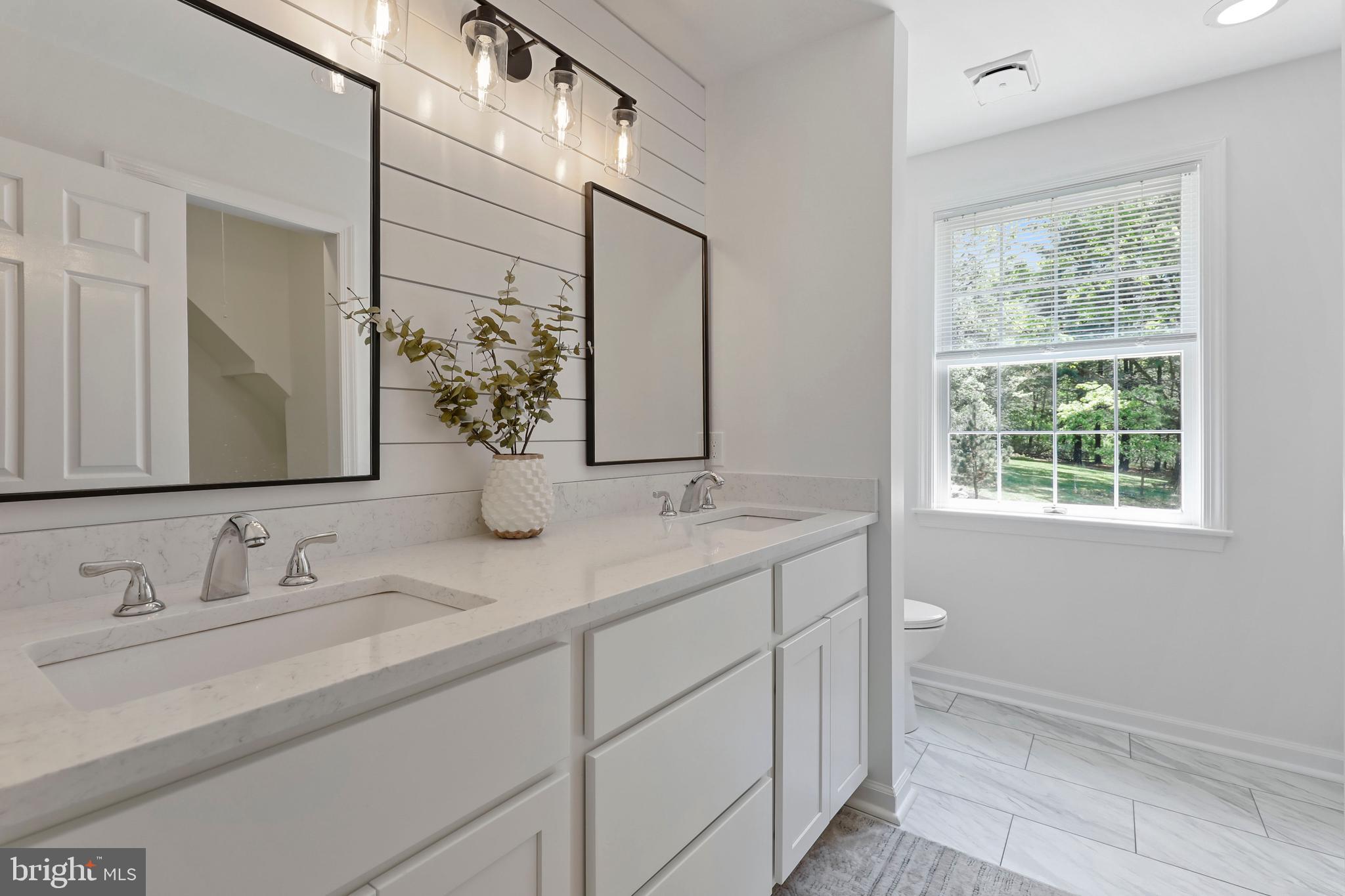 19625 Gunpowder Road Manchester, MD 21102 - Photo 21 of 44 a bathroom with a double vanity sink and a mirror