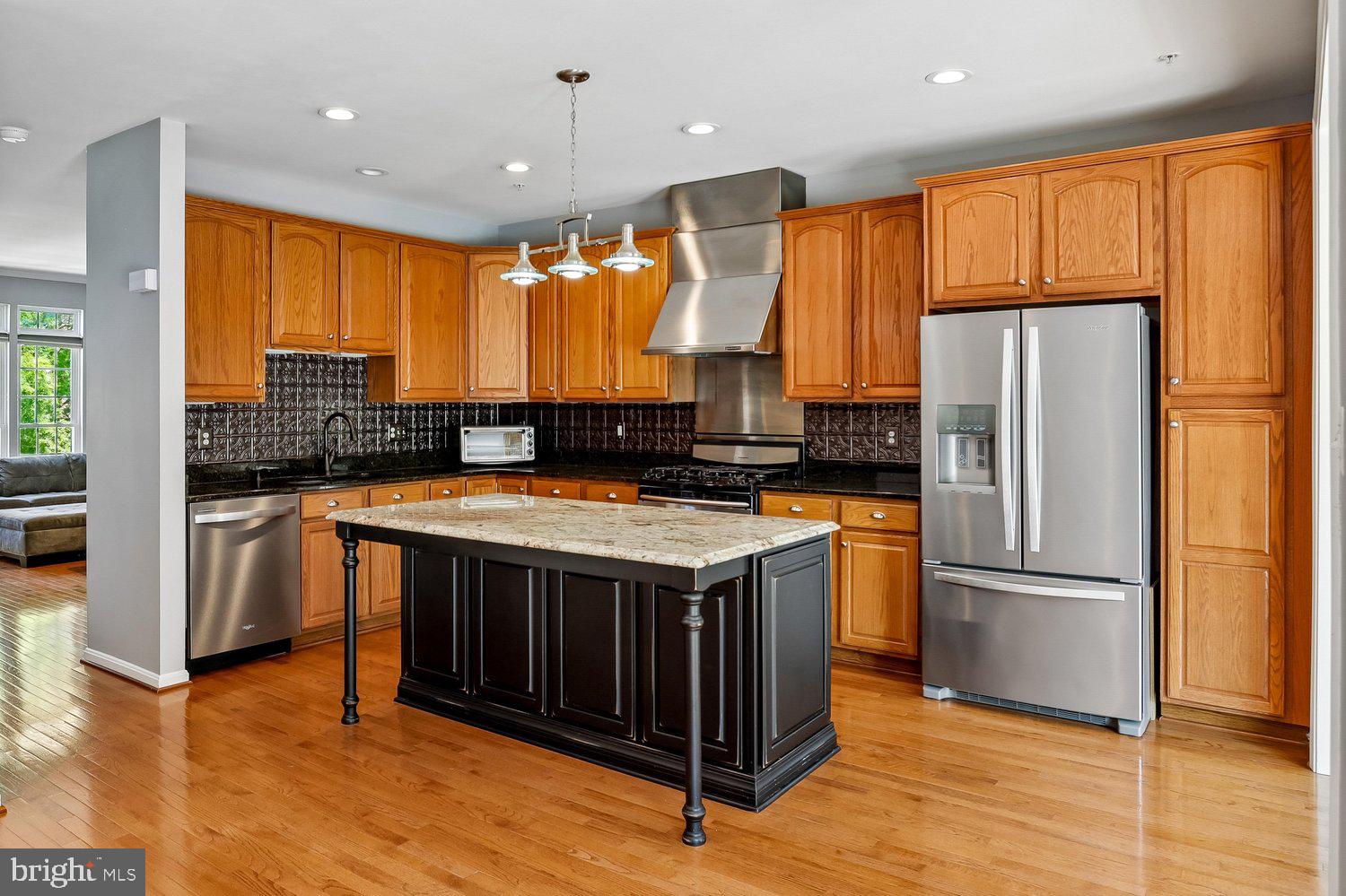 2396 Jostaberry Way Odenton, MD 21113 - Photo 13 of 55 a kitchen with stainless steel appliances granite countertop a stove a refrigerator and a sink