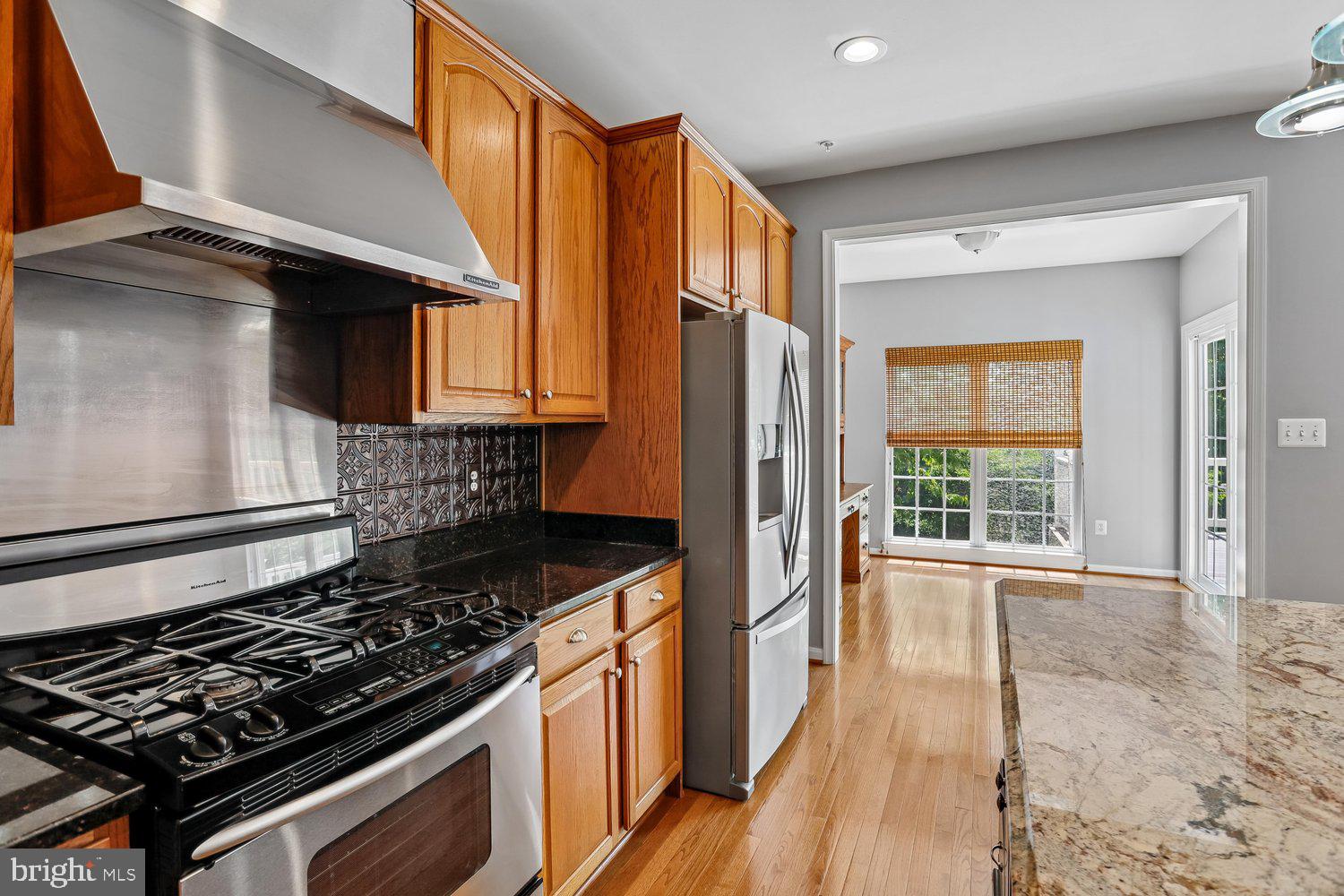 2396 Jostaberry Way Odenton, MD 21113 - Photo 15 of 55 a kitchen with stainless steel appliances granite countertop a stove a sink and a refrigerator