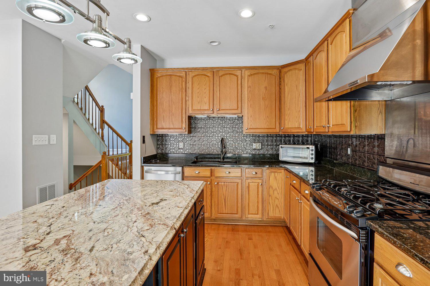 2396 Jostaberry Way Odenton, MD 21113 - Photo 16 of 55 a kitchen with stainless steel appliances granite countertop a sink stove and refrigerator
