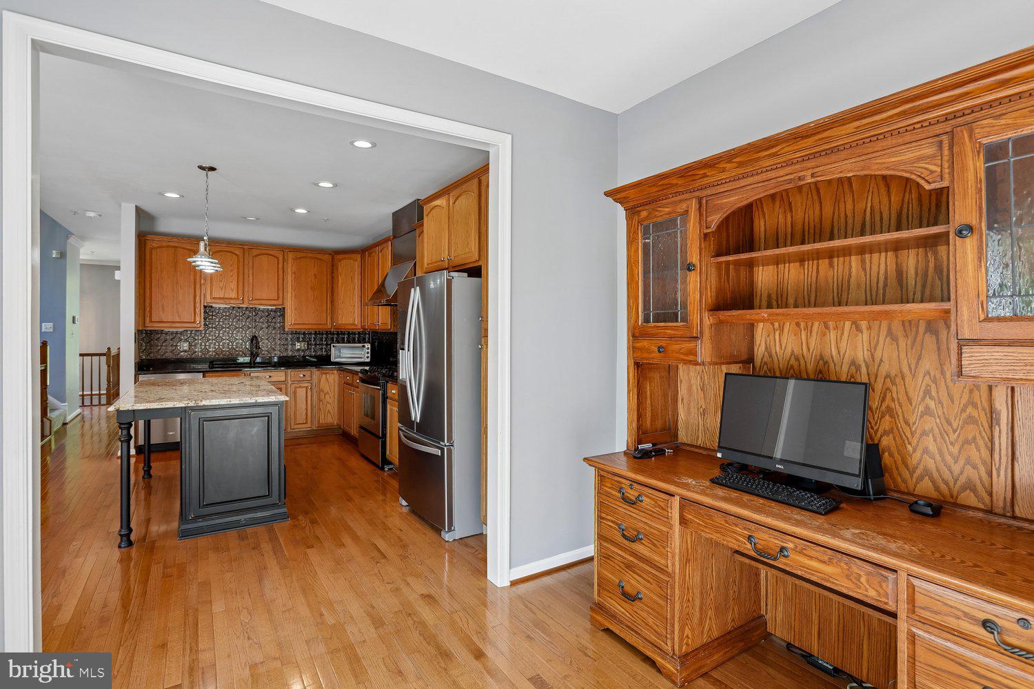2396 Jostaberry Way Odenton, MD 21113 - Photo 20 of 55 a kitchen with a refrigerator microwave and stove top oven