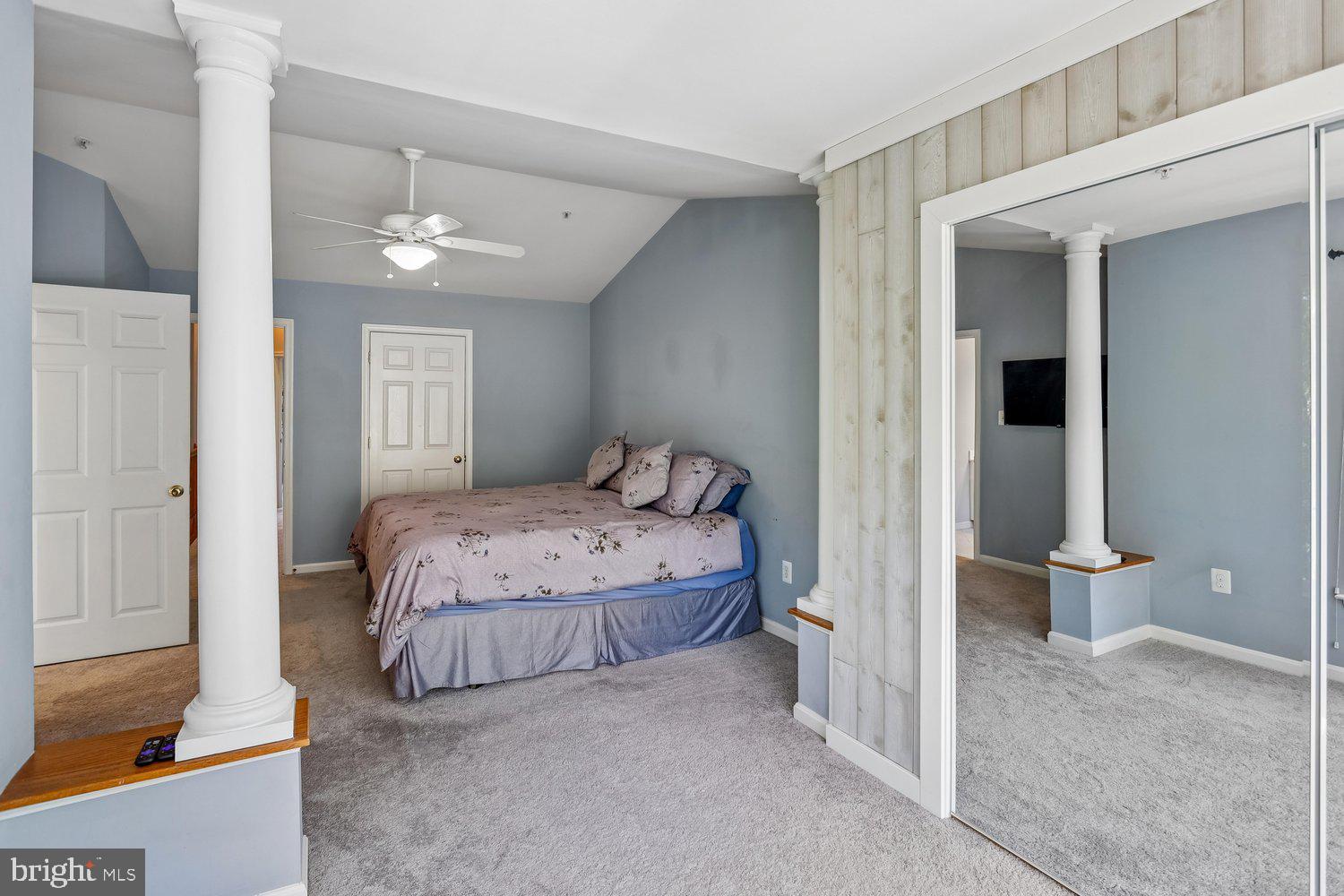 2396 Jostaberry Way Odenton, MD 21113 - Photo 29 of 55 a bedroom with a large bed and a chandelier
