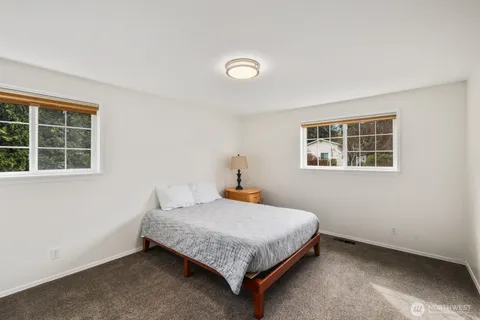 a bedroom with a bed and window