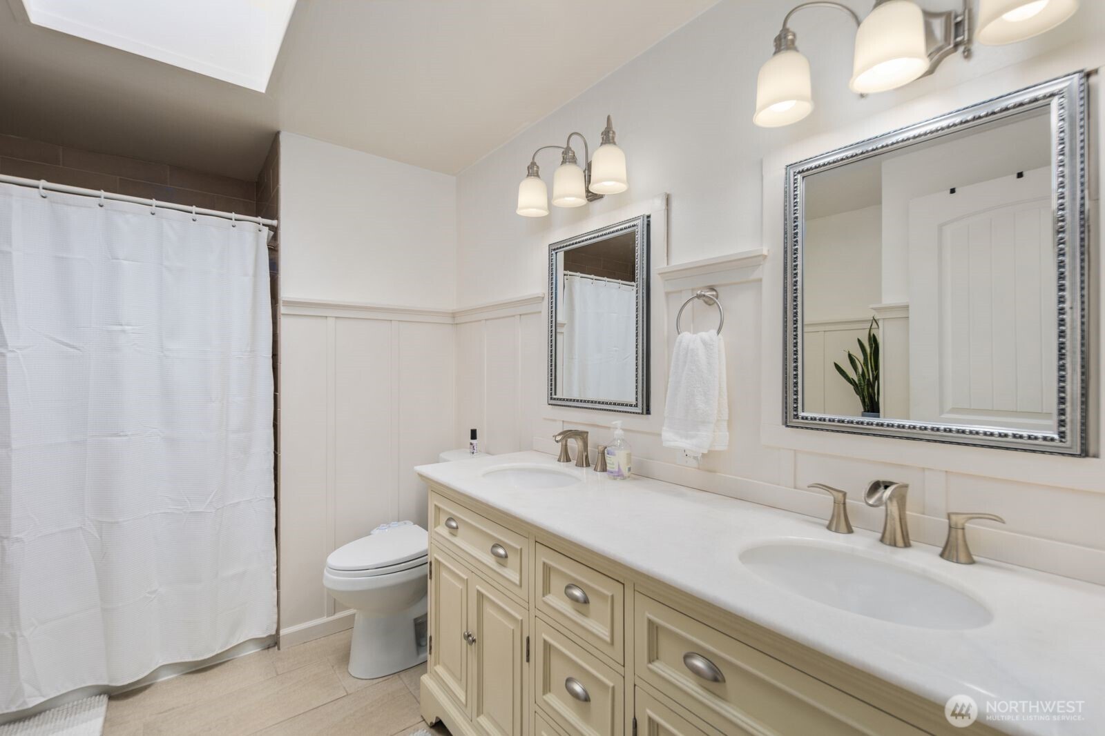 10400 Southeast 194th Place Renton, WA 98055 - Photo 15 of 25 a bathroom with double vanity sink a mirror and a toilet