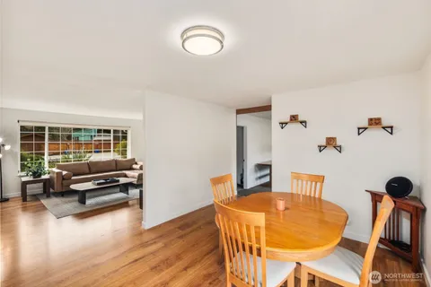 a view of a livingroom with furniture wooden floor and a window