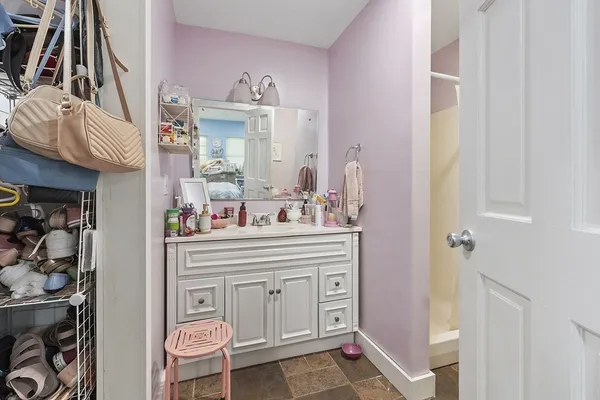 a bathroom with mirror cabinets and a sink
