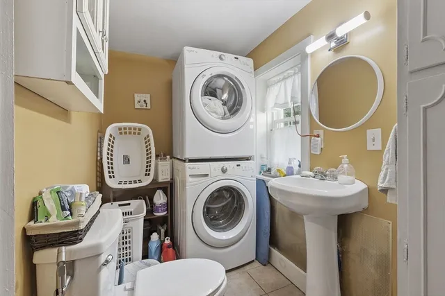 a bathroom with a toilet mirror and tub