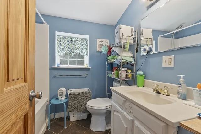 a bathroom with a toilet sink and mirror