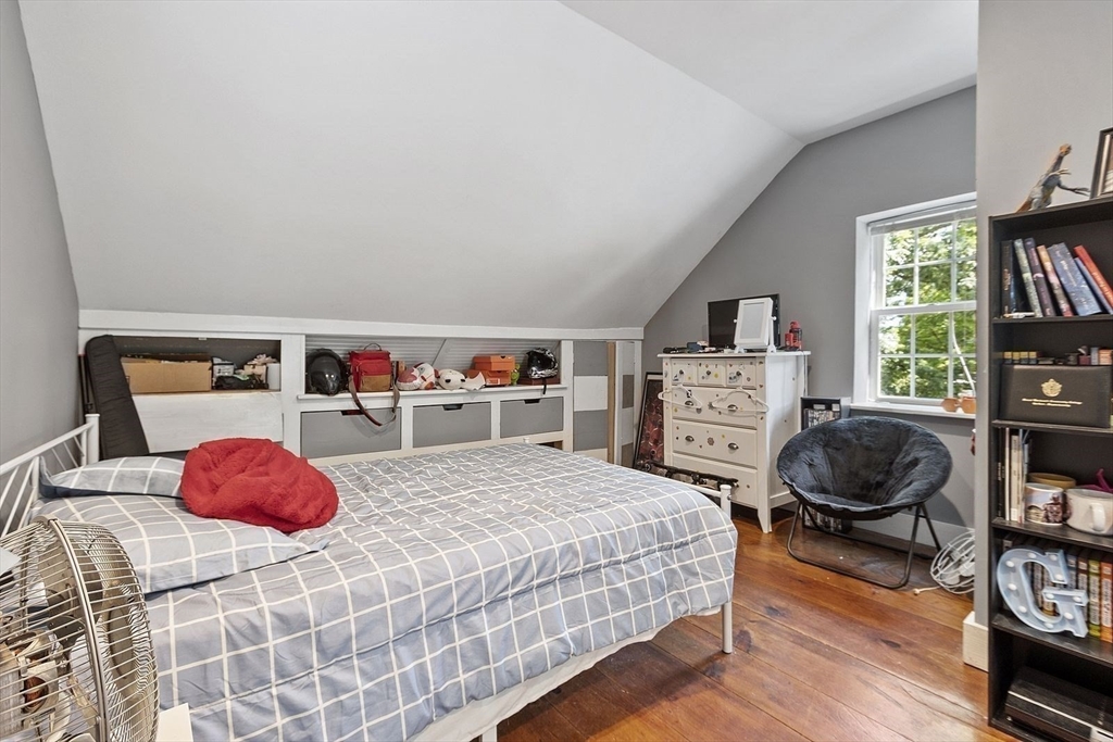 610 South Main Street Orange, MA 01364 - Photo 19 of 38 a bedroom with a bed a dresser and a book shelf