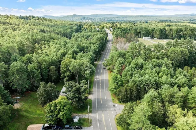 a view of a patio with dining table and chairs with wooden floor and fence