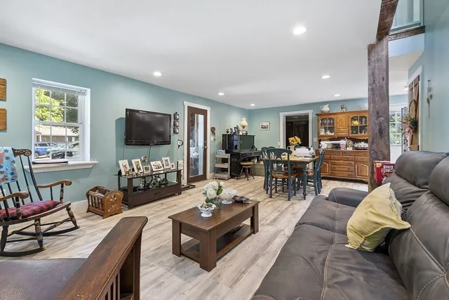a living room with furniture fireplace and a flat screen tv